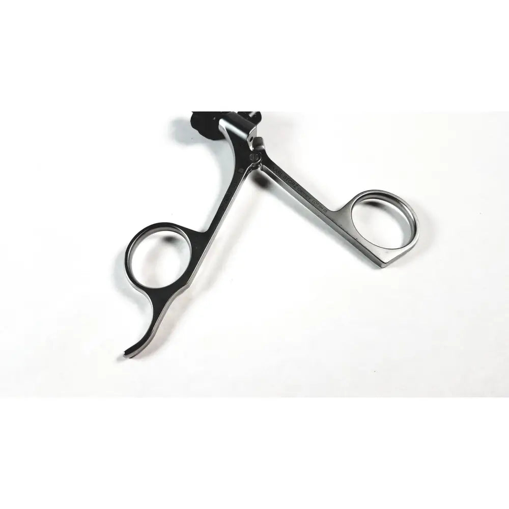 Black and silver karl storz clickline metal handle pistol grip surgical instrument with sleek metallic finish