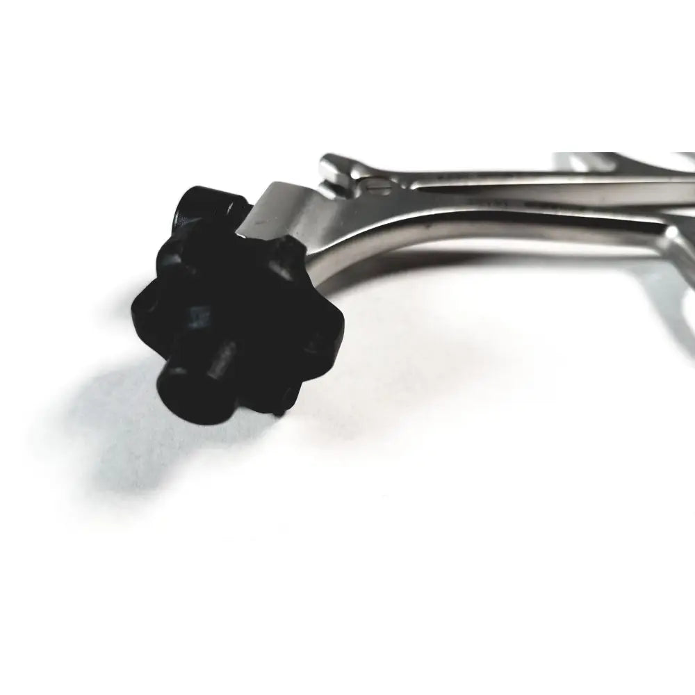 Black plastic adjustment knob on the metallic karl storz clickline metal handle pistol grip surgical instrument