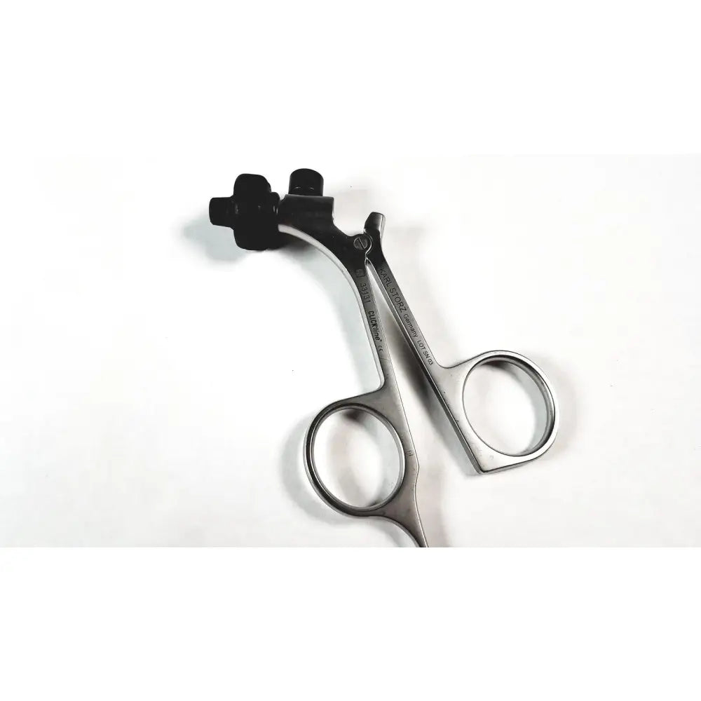 Silver surgical scissors with black ergonomic handles and Karl Storz engraved branding featuring clickline metal handle