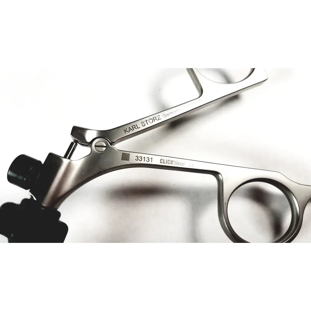 Silver karl storz 33131 clickline bowel grasper laparoscopic instrument with black ergonomic handles and engraved details
