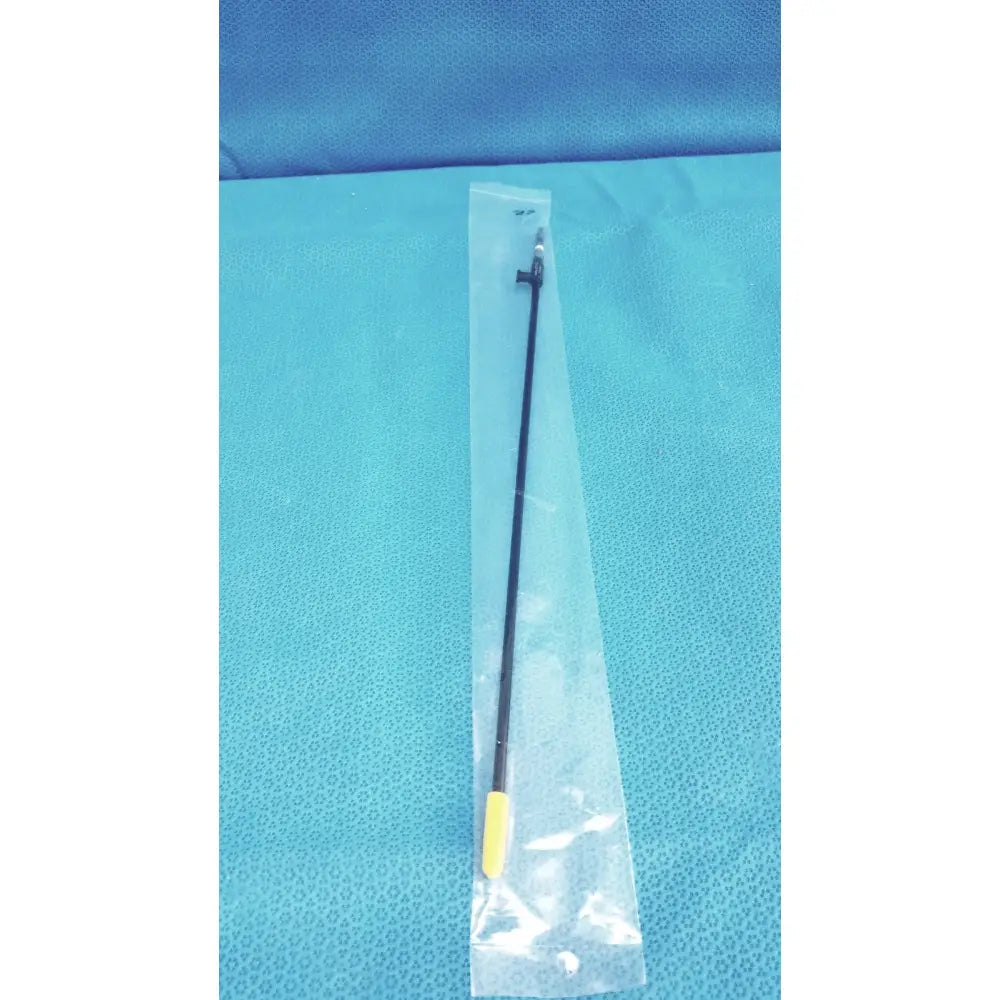 Black karl storz insulated outer tube surgical instrument with yellow tip packaged in clear plastic for medical use