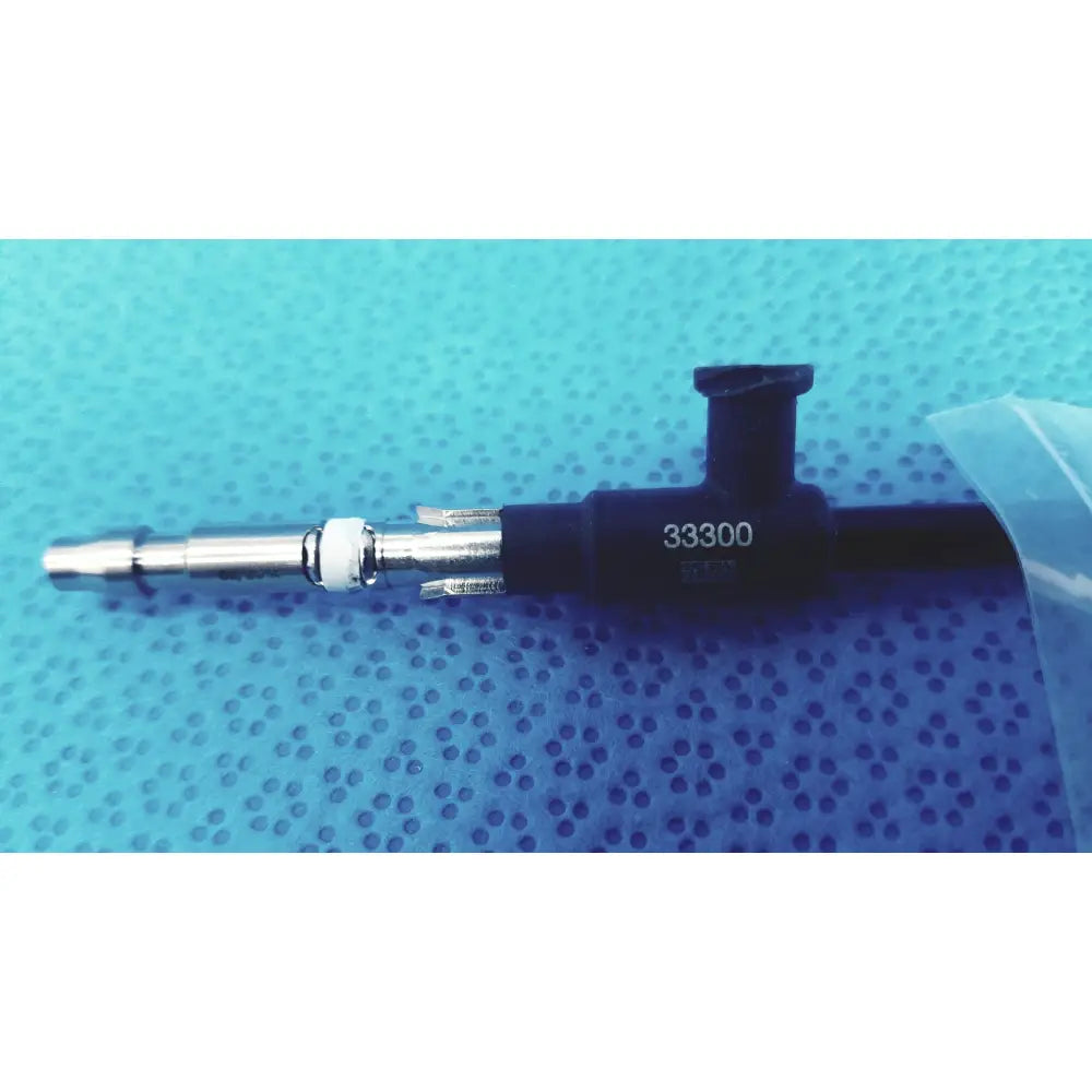 Black and silver Karl Storz 33300 outer tube clickline instrument with engraved number 33300 on the fuel injector body