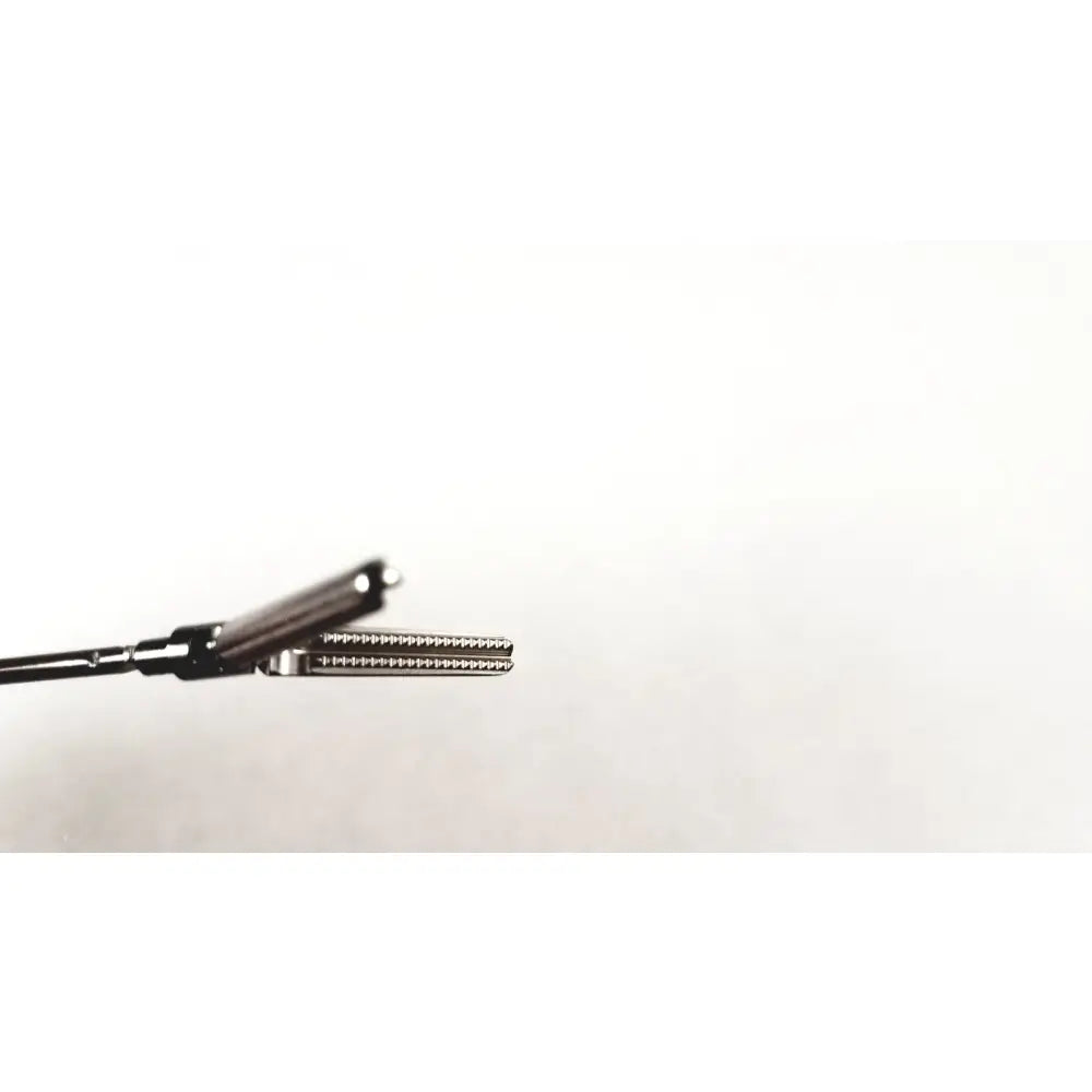 Black karl storz clickline grasping insert surgical forceps with textured serrated gripping surface and metallic joints