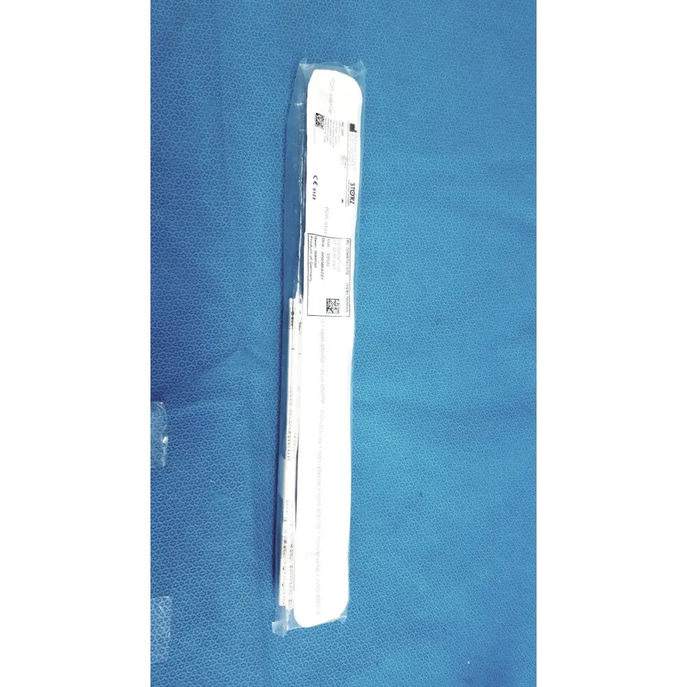 White surgical instrument wrapped in clear plastic packaging of karl storz clickline insulated outer sheath tube