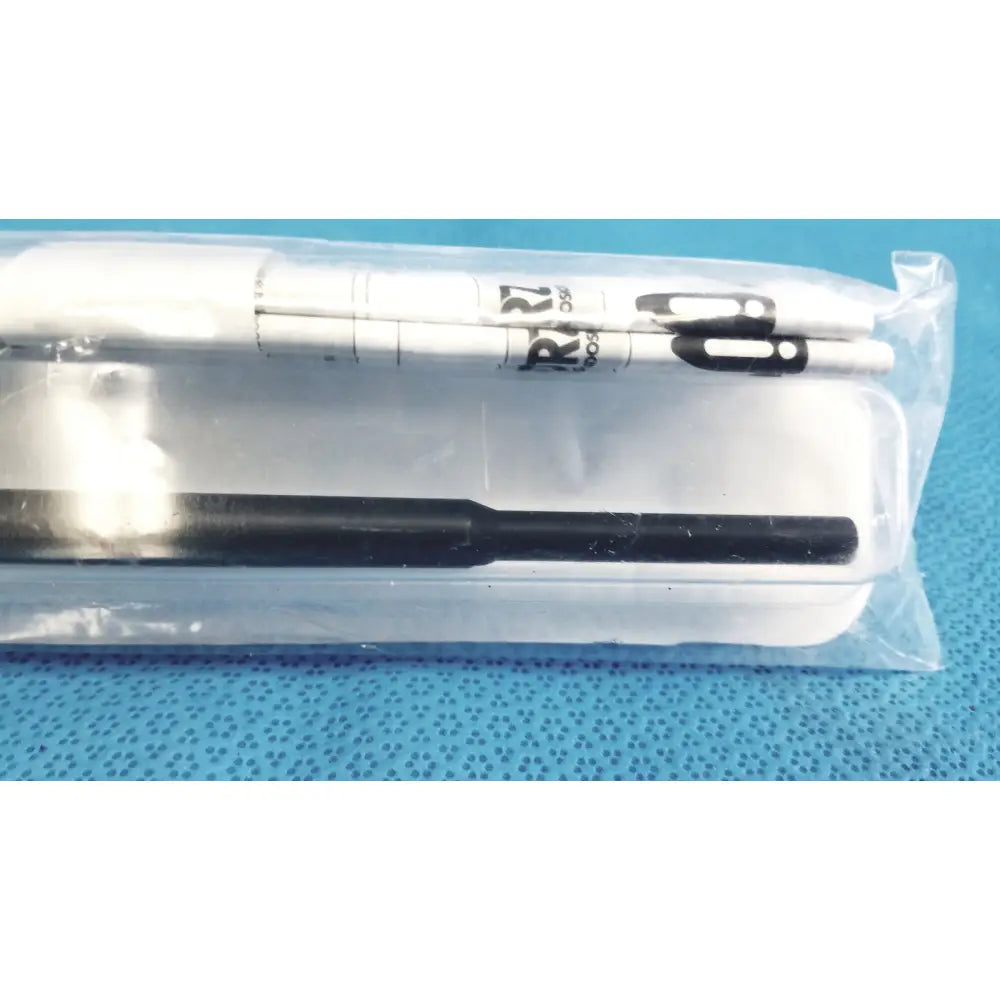 White and black marker pens in clear plastic packaging alongside karl storz clickline insulated outer sheath tube