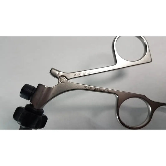 Silver surgical forceps with black rubberized handles branded karl storz clickline model 33131 for medical use