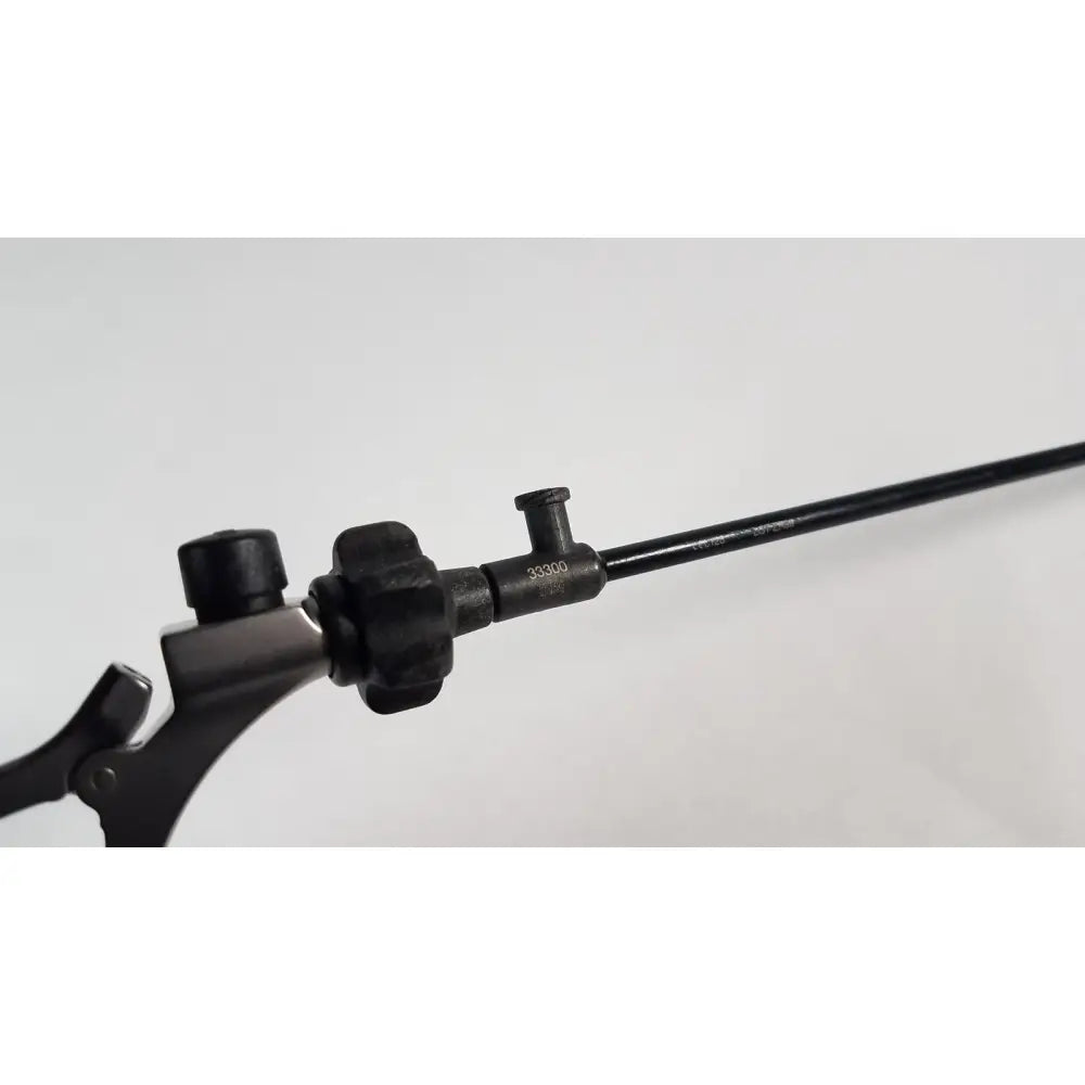Black surgical instrument with textured handle and long slender shaft for precise use karl storz clickline model