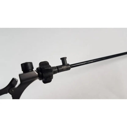 Black surgical instrument with textured handle and long slender shaft for precise use karl storz clickline model