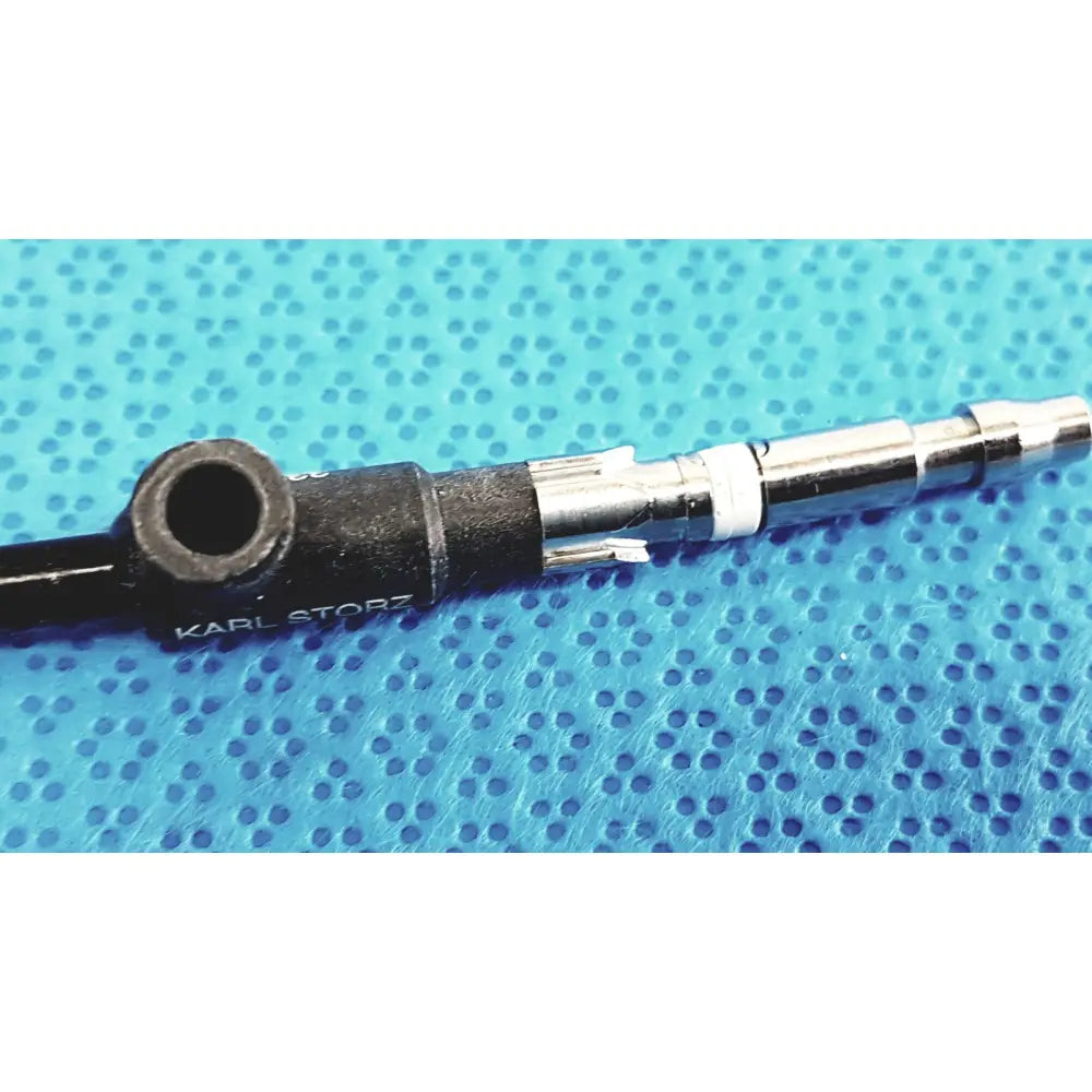 Black and silver karl storz clickline insulated outer sheath with textured grip and metallic connector for surgical use