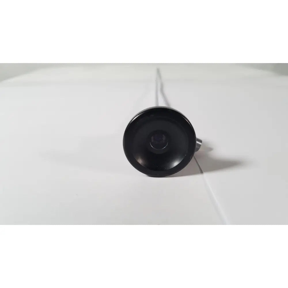 Black circular camera lens with metallic stem of karl storz hopkins 27023 a 0 degree endoscope front side view