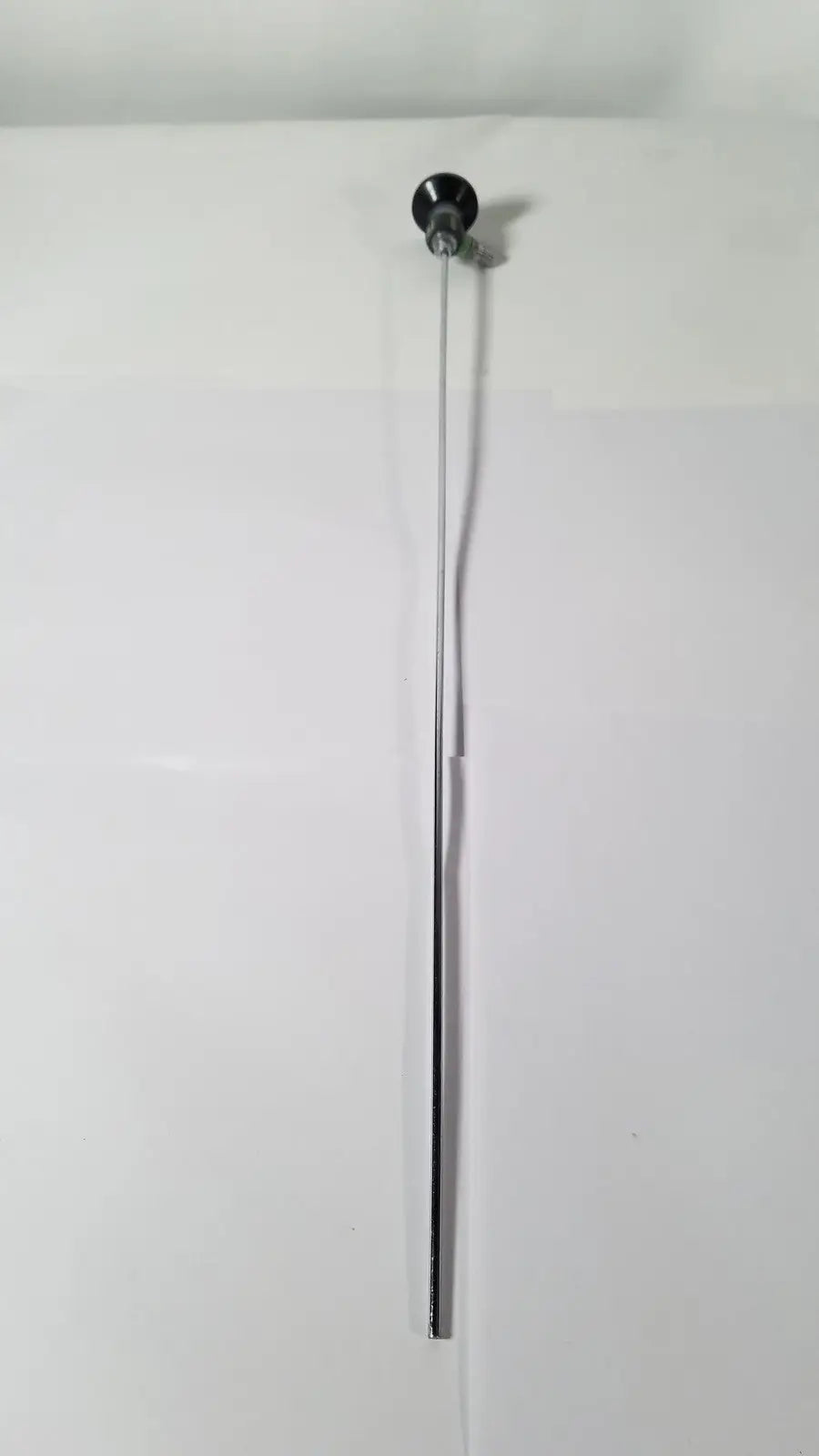 A sleek metallic rod with a polished black spherical knob from the karl storz hopkins 27023 a 0 degree endoscope