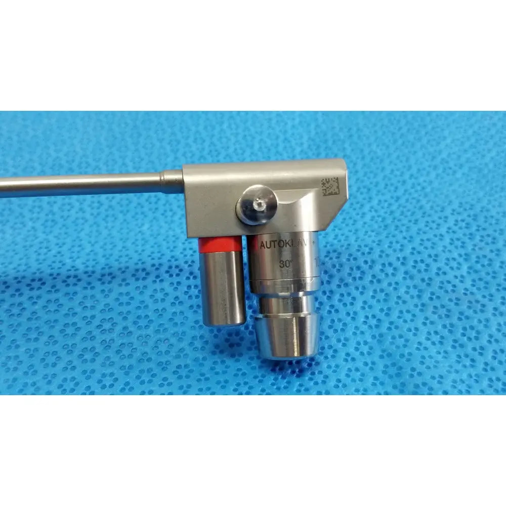 Silver metallic karl storz hopkins surgical endoscope with 30 degree angled lens and red-tipped control mechanism