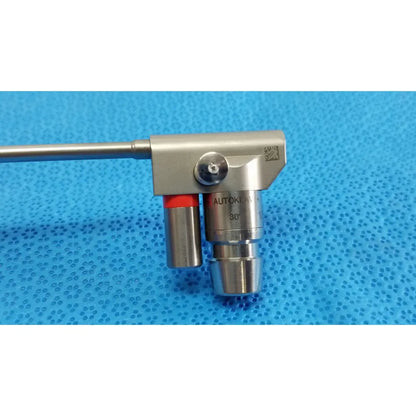 Silver metallic karl storz hopkins surgical endoscope with 30 degree angled lens and red-tipped control mechanism