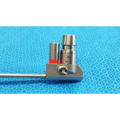 Silver karl storz hopkins 30º autoclavable telescope with cylindrical handle and red-capped metal component on base