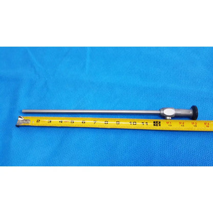 Silver karl storz hopkins ii 0° 26003 aa autoclavable laparoscope endoscope with black tip and metallic handle beside yellow tape