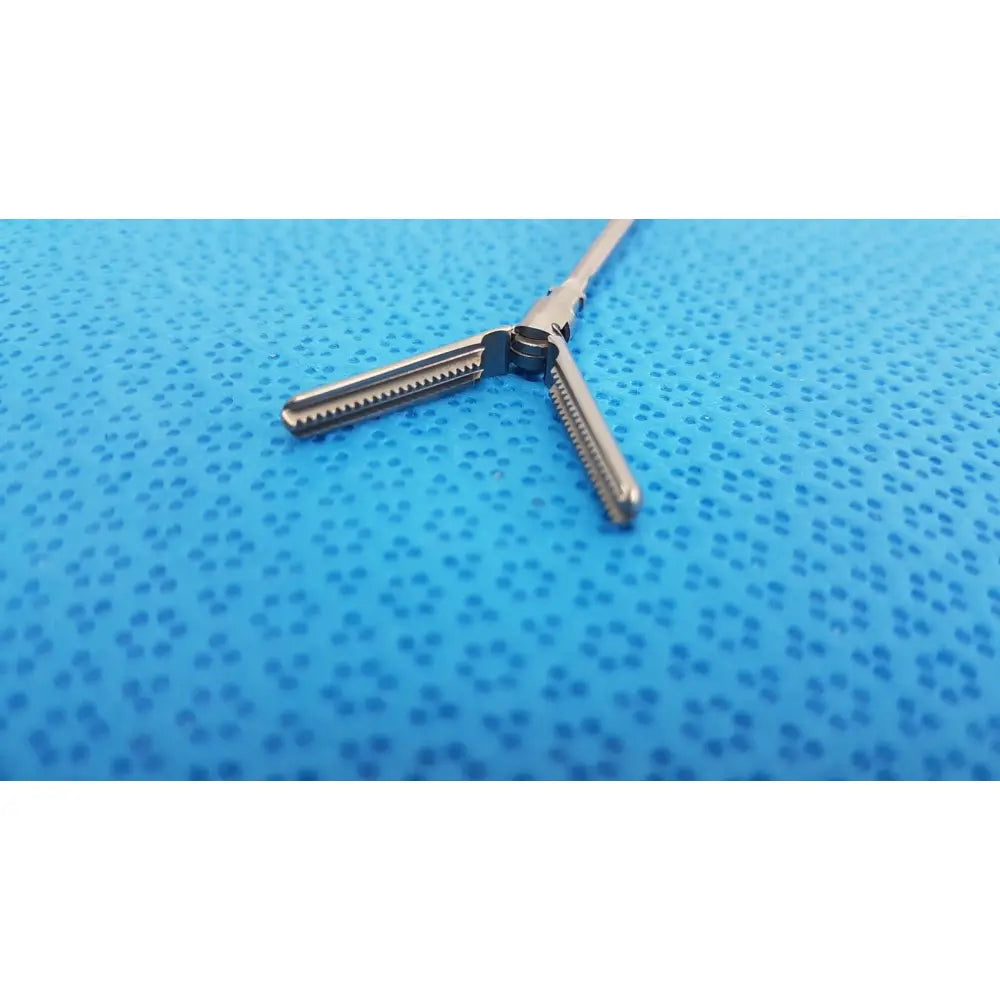 Silver karl storz laparoscopic grasper model 33410 dyd with y-shaped handle and serrated jaws for surgical use