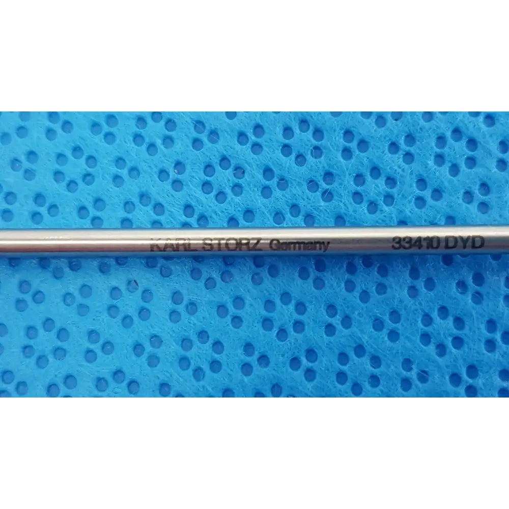 A sleek metallic karl storz laparoscopic grasper model 33410 dyd with engraved branding and model number