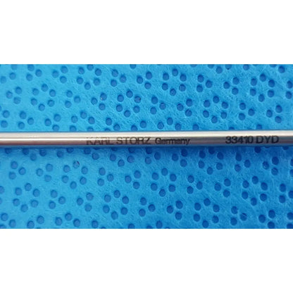 A sleek metallic karl storz laparoscopic grasper model 33410 dyd with engraved branding and model number