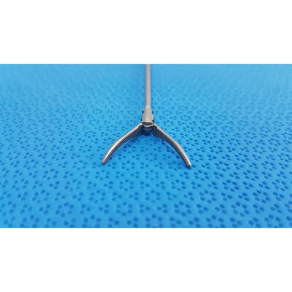 Silver karl storz laparoscopic grasper model 33410ml with long slender shaft and three-pronged serrated tips