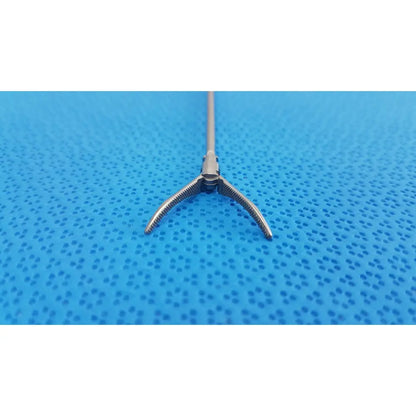 Silver karl storz laparoscopic grasper model 33410ml with long slender shaft and three-pronged serrated tips