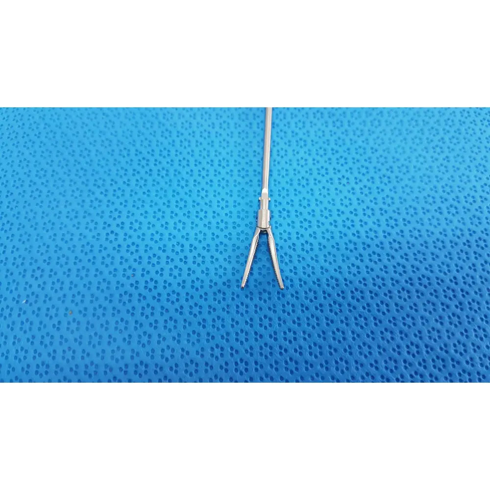 Silver metallic karl storz laparoscopic grasper model 33410ml with slender shaft and curved pointed jaws