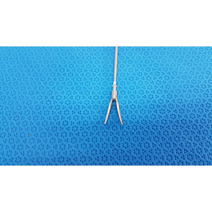 Silver metallic karl storz laparoscopic grasper model 33410ml with slender shaft and curved pointed jaws