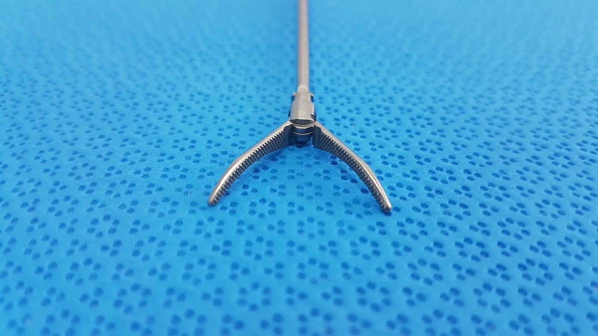 Silver karl storz laparoscopic grasper model 33410ml with long slender shaft and three-pronged serrated tips