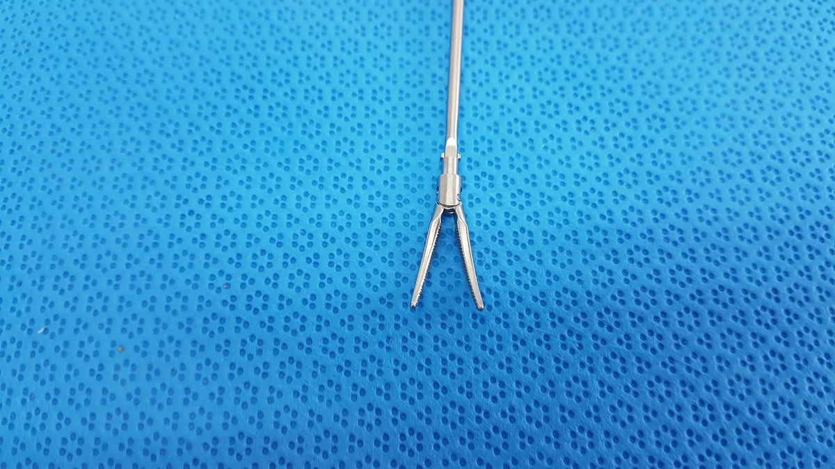 Silver metallic karl storz laparoscopic grasper model 33410ml with slender shaft and curved pointed jaws
