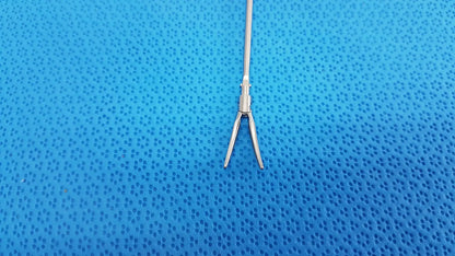 Silver metallic karl storz laparoscopic grasper model 33410ml with slender shaft and curved pointed jaws