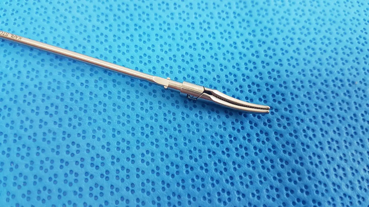 Silver karl storz laparoscopic grasper model 33410ml with long slender shaft and curved serrated jaws