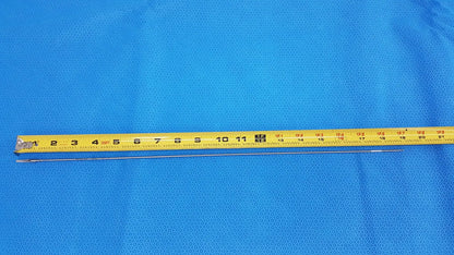 Yellow measuring tape with black markings and metallic blade featured with karl storz laparoscopic grasper model 33410ml