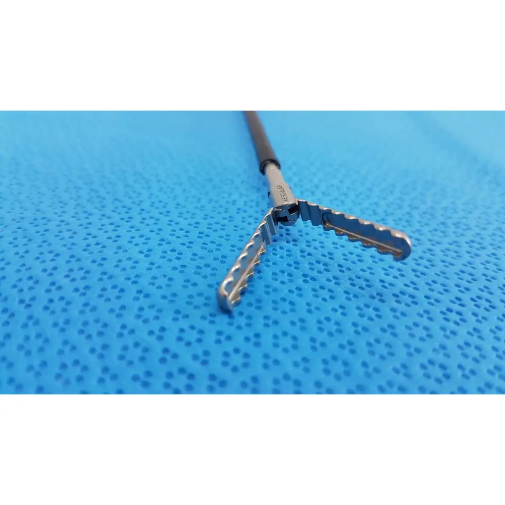 Silver karl storz laparoscopic sheath model 33400 with black handle and serrated interlocking jaws for surgical use