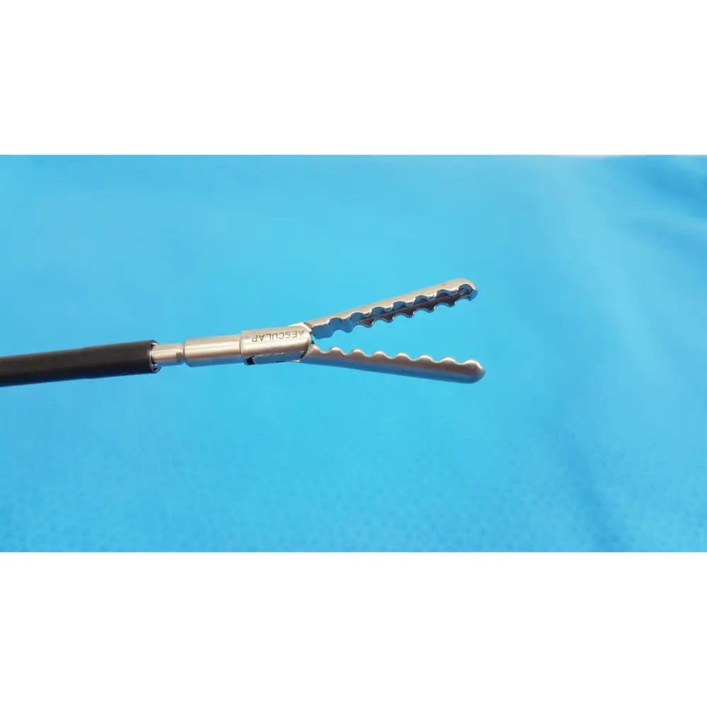 Silver karl storz laparoscopic sheath model 33400 with serrated jaws black handle branded vascular on metallic shaft