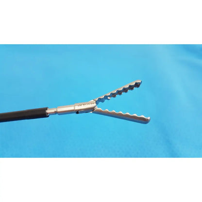 Silver surgical forceps with serrated wavy jaws and black handle in karl storz laparoscopic sheath model 33400