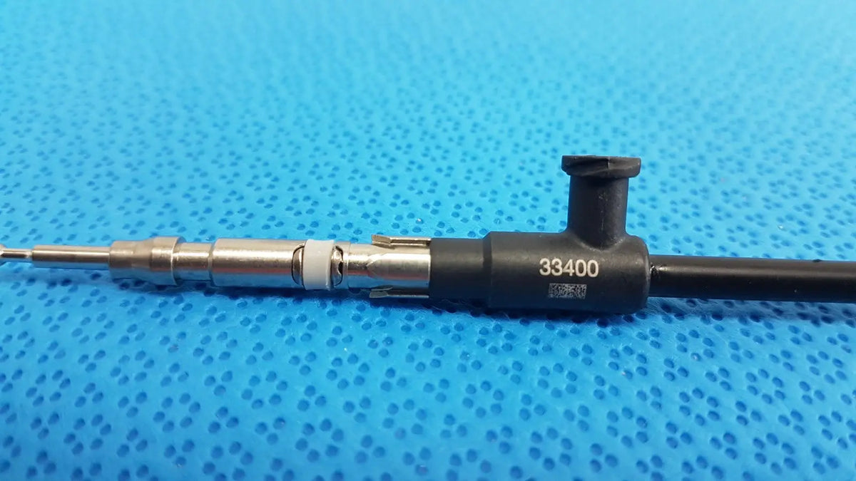 Black and silver karl storz laparoscopic sheath model 33400 featuring a fuel injector design for surgical use