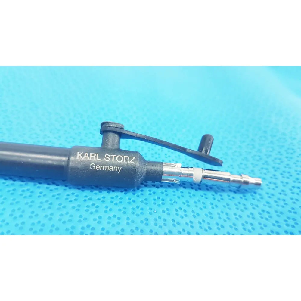 Black karl storz laparoscopic surgical instrument model 33500 with metallic connector and protective cap