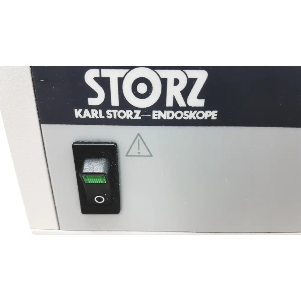 Black toggle switch with green illuminated indicator on gray karl storz scb image 1 hub endoscope camera control unit
