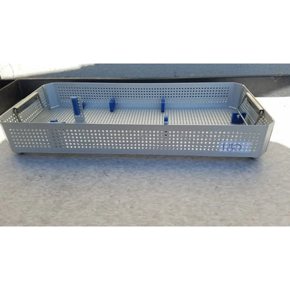 Silver perforated metal Karl Storz sterilization container case with blue plastic dividers for surgical instruments
