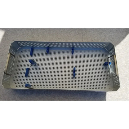 Stainless steel surgical instrument tray with blue plastic clasps in karl storz sterilization container case for instruments