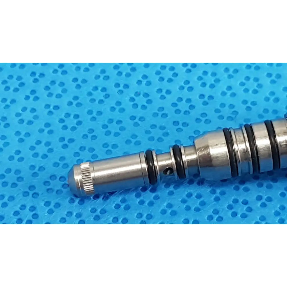 Silver metallic valve spool with black rubber seals and threaded end cap for kavo pin 460led coupler dental connector