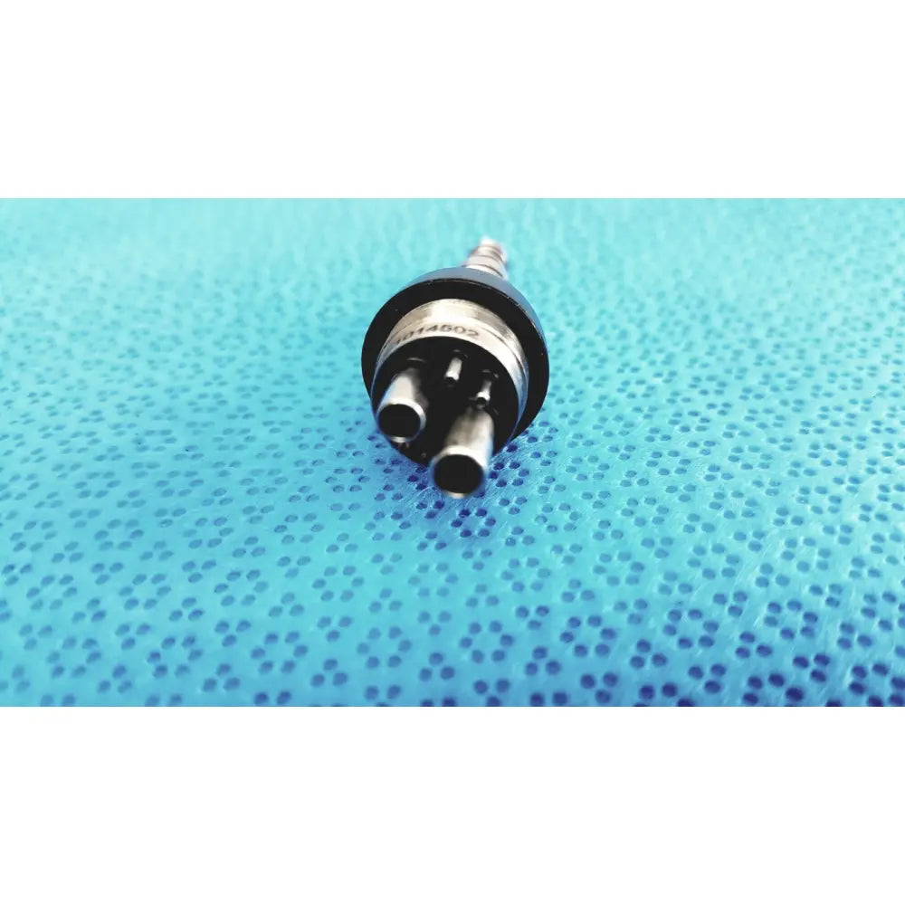 Black and silver led multiflex lux 6-pin coupler with three cylindrical ports for dental handpiece connection