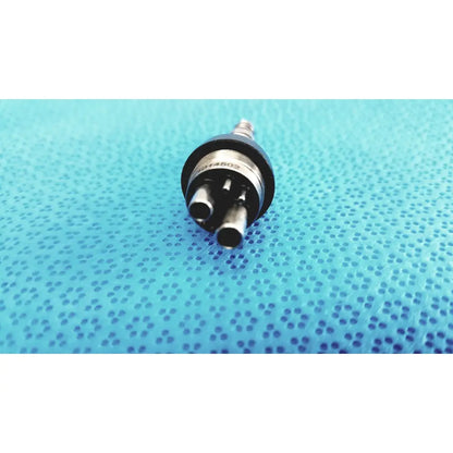 Black and silver led multiflex lux 6-pin coupler with three cylindrical ports for dental handpiece connection