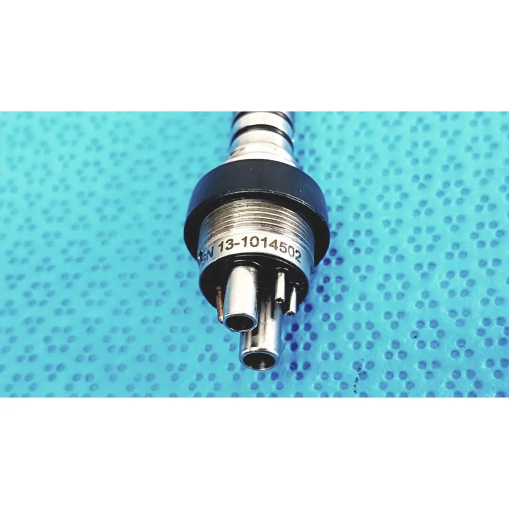Silver metallic KAVO 460 LED MULTIflex LUX 6-pin coupler with black rubber seal and three ports for dental handpiece connection