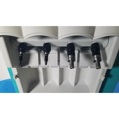 Four black and silver dental drill bits mounted in white holder for kavo quattrocare 2104a dental handpiece maintenance unit