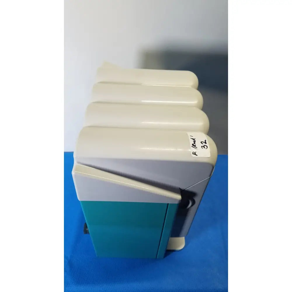 Cream and teal two-tone plastic electric heater with ribbed top section for KaVo QUATTROcare 2104A dental handpiece maintenance unit
