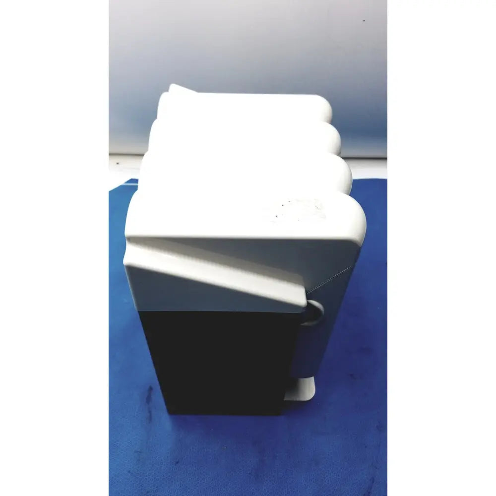 White and black plastic kavo quattrocare plus 2124 a handpiece maintenance system box with rounded edges and hinged lid
