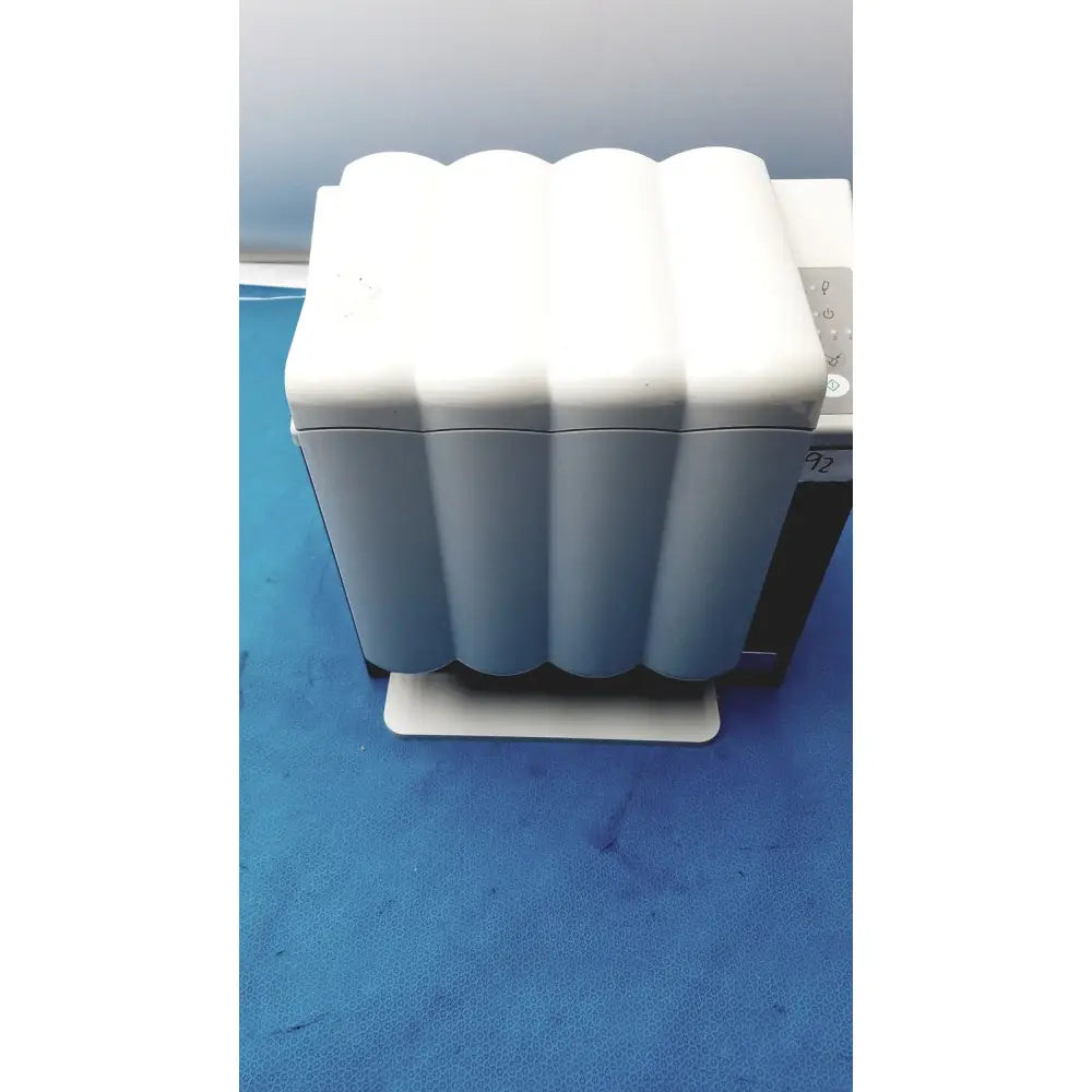 White wavy-edged plastic handpiece maintenance device with rectangular base for KaVo Quattrocare Plus system