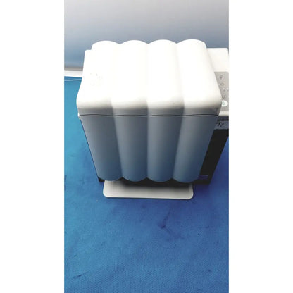 White wavy-edged plastic handpiece maintenance device with rectangular base for KaVo Quattrocare Plus system