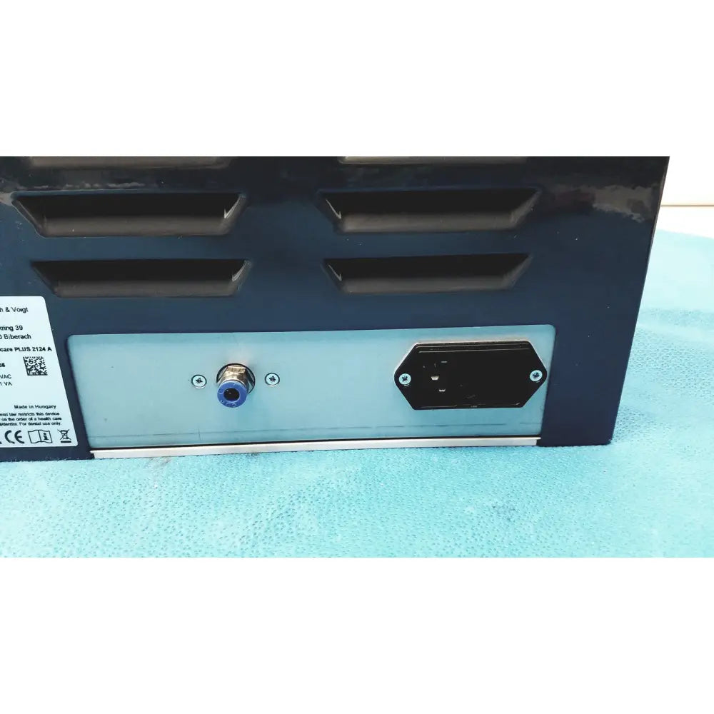 Black and silver industrial power supply unit with blue-capped input port and ventilation slits on back for kavo quattrocare plus