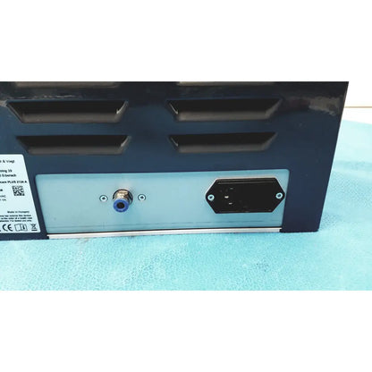 Black and silver industrial power supply unit with blue-capped input port and ventilation slits on back for kavo quattrocare plus
